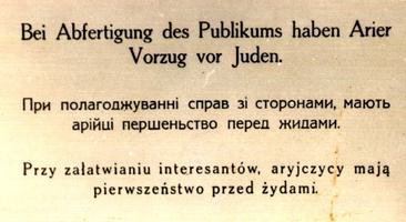 A sign with German, Russian and Polish writing.
