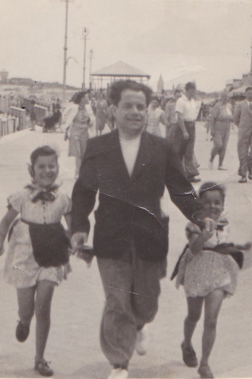 Bracha (left) with her sister Sara and their father on a family vacation, enjoying the day at the beach. Heist-aan-Zee, Belgium, circa 1938.