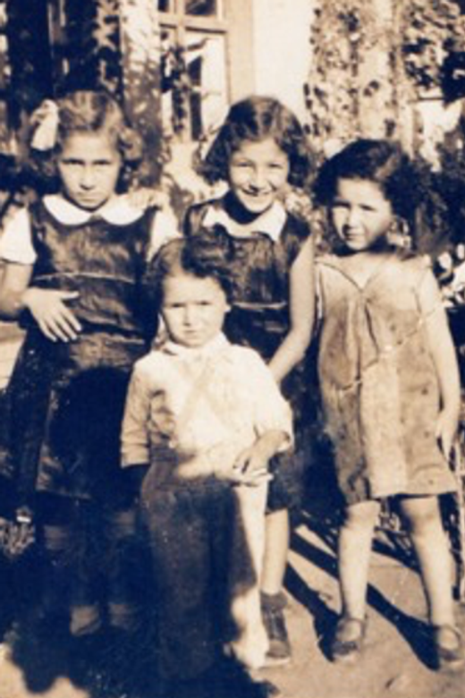 Judit (in back, left) with her sisters Ági (centre) and Anni (right). Their younger brother, Pista, is standing in front. Debrecen, Hungary, date unknown.